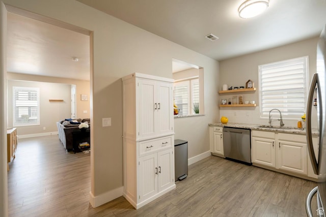 4947 W Calton Ln, South Jordan, UT 84009 - kitchen with appliances with stainless steel finishes, visible vents, light wood-type flooring, and a sink