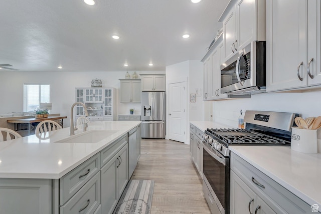 3498 N Delta St, Eagle Mountain, UT 84005 - kitchen with appliances with stainless steel finishes, a sink, light countertops, gray cabinetry, and recessed lighting