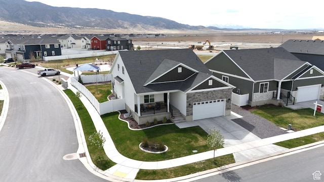 3498 N Delta St, Eagle Mountain, UT 84005 - view of front of home featuring a residential view, concrete driveway, a garage, a porch, and a mountain view