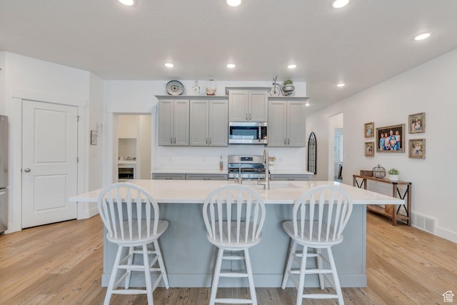 3498 N Delta St, Eagle Mountain, UT 84005 - kitchen featuring appliances with stainless steel finishes, a sink, light countertops, gray cabinetry, and recessed lighting