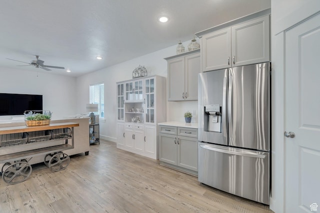 3498 N Delta St, Eagle Mountain, UT 84005 - kitchen with stainless steel fridge, a ceiling fan, light wood-type flooring, light countertops, and baseboards