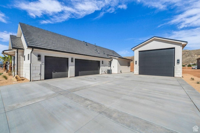 1907 S 950 W, Hurricane, UT 84737 - view of side of home with concrete driveway, a garage, stucco siding, and central AC unit