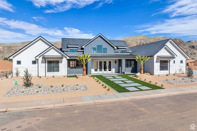 1907 S 950 W, Hurricane, UT 84737 - view of front facade with a standing seam roof, french doors, board and batten siding, and a mountain view