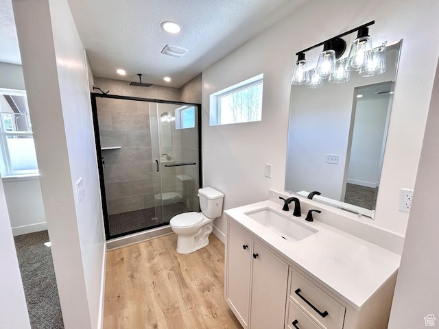 991 N 2500 W, Vernal, UT 84078 - bathroom with a shower stall, baseboards, toilet, wood finished floors, and vanity