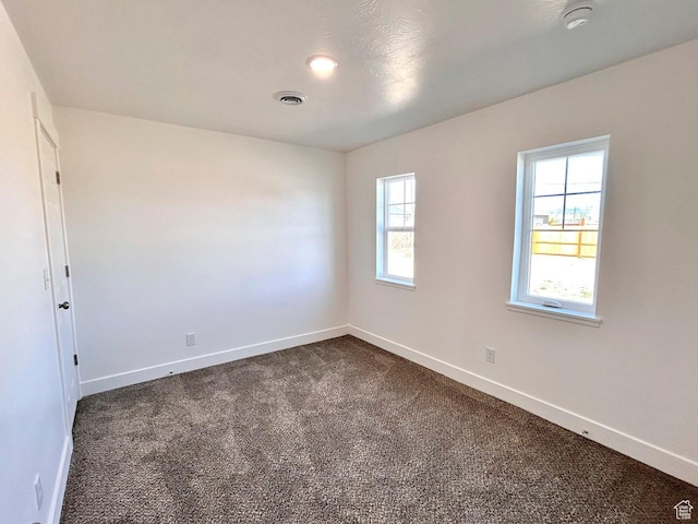 991 N 2500 W, Vernal, UT 84078 - unfurnished room featuring baseboards, visible vents, and dark carpet