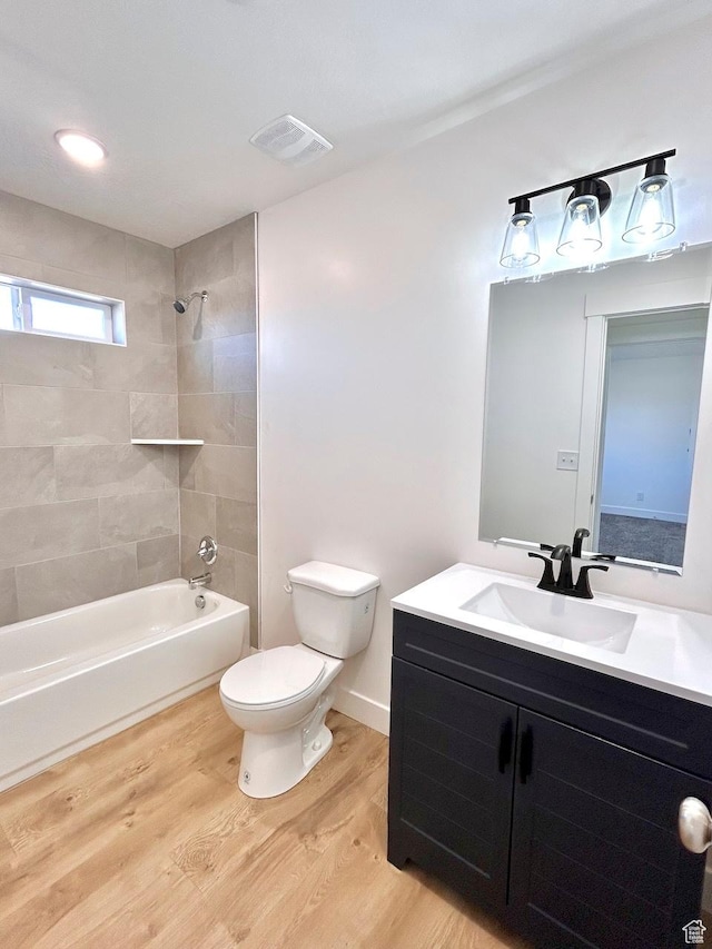 991 N 2500 W, Vernal, UT 84078 - bathroom with washtub / shower combination, visible vents, toilet, wood finished floors, and vanity