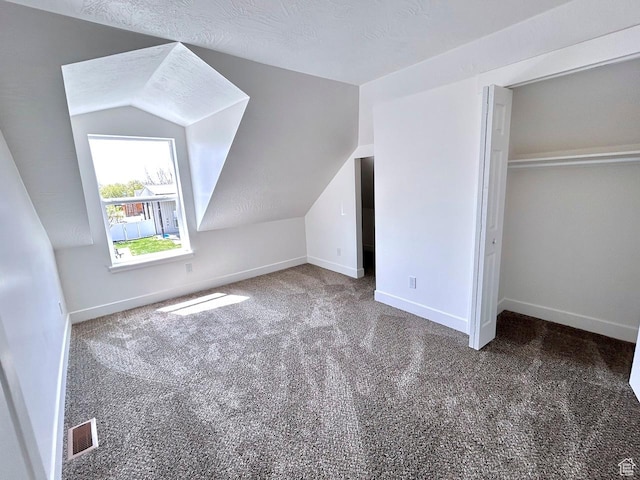 991 N 2500 W, Vernal, UT 84078 - additional living space with lofted ceiling, visible vents, carpet floors, and baseboards
