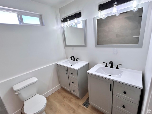 991 N 2500 W, Vernal, UT 84078 - bathroom with two vanities, wood finished floors, toilet, and a sink