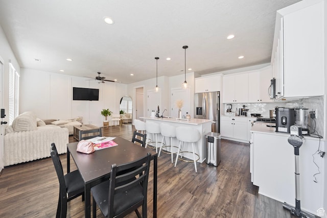 11412 S Regalstone Dr, South Jordan, UT 84009 - dining room with arched walkways, dark wood-style floors, ceiling fan, and plenty of natural light