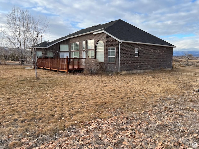 5867 W 4000 N, Roosevelt, UT 84066 - view of property exterior featuring roof with shingles, a deck, and brick siding