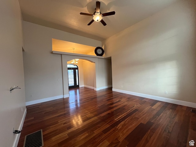 5867 W 4000 N, Roosevelt, UT 84066 - spare room featuring dark wood-type flooring, visible vents, ceiling fan with notable chandelier, and arched walkways