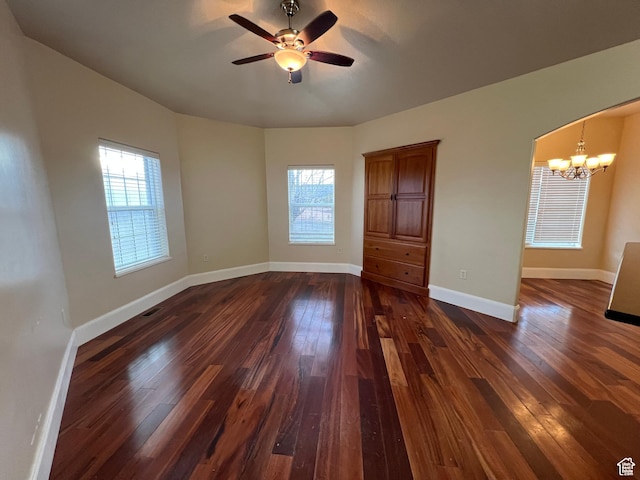5867 W 4000 N, Roosevelt, UT 84066 - empty room featuring baseboards, ceiling fan with notable chandelier, and dark wood-type flooring