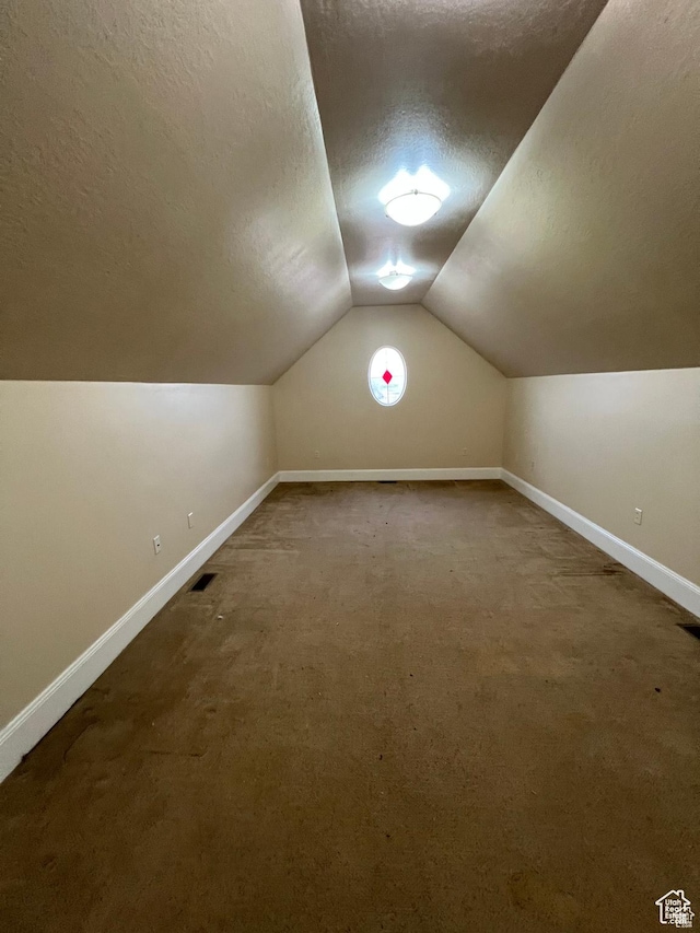 5867 W 4000 N, Roosevelt, UT 84066 - additional living space featuring vaulted ceiling, a textured ceiling, carpet, and baseboards