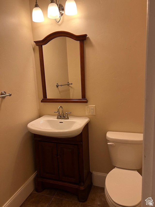 5867 W 4000 N, Roosevelt, UT 84066 - bathroom featuring baseboards, toilet, tile patterned flooring, and vanity