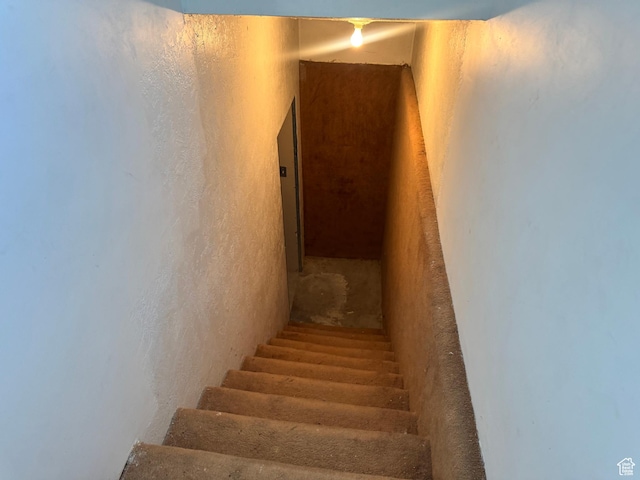 stairs featuring a textured wall