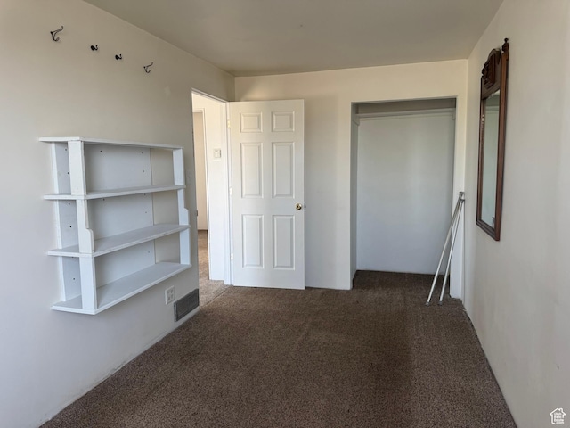 unfurnished bedroom with carpet floors and a closet
