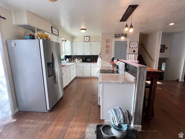 10 N 700 E, Roosevelt, UT 84066 - kitchen with dark wood finished floors, stainless steel fridge with ice dispenser, light countertops, white cabinets, and a peninsula