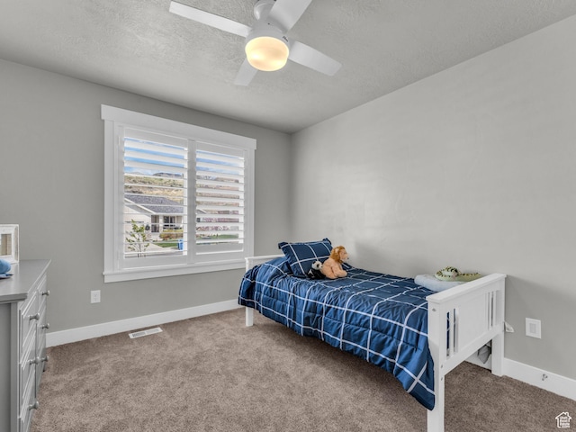 13952 S Indian Ln E, Herriman, UT 84096 - bedroom with carpet floors, a textured ceiling, baseboards, and ceiling fan