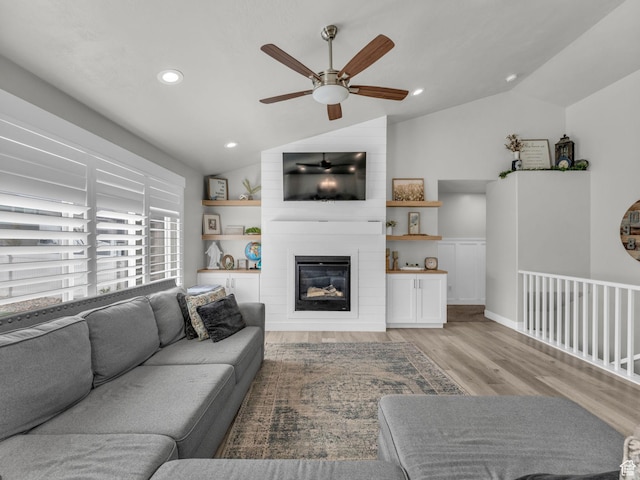 13952 S Indian Ln E, Herriman, UT 84096 - living area with lofted ceiling, ceiling fan, light wood finished floors, a fireplace, and recessed lighting