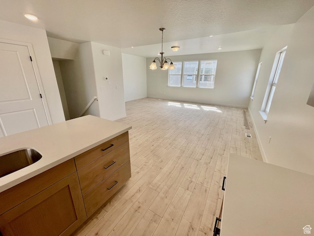 12975 S Spook Gulch Ct Unit 621, Riverton, UT 84096 - unfurnished dining area featuring an inviting chandelier, baseboards, and light wood-style floors