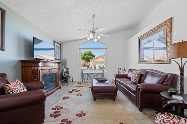 2369 S 780 W, Hurricane, UT 84737 - living area featuring a tiled fireplace, a ceiling fan, a textured ceiling, and lofted ceiling