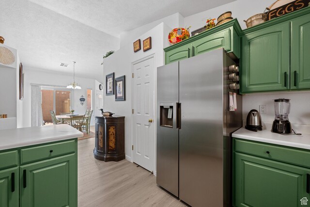 2369 S 780 W, Hurricane, UT 84737 - kitchen featuring a textured ceiling, light wood-style floors, light countertops, an inviting chandelier, and stainless steel fridge