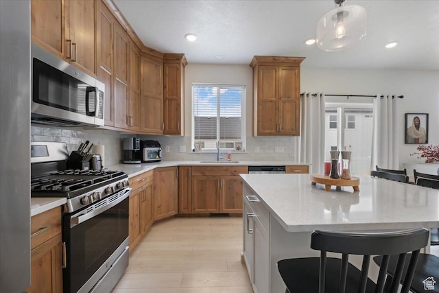 574 W 500 N, Smithfield, UT 84335 - kitchen with a breakfast bar area, appliances with stainless steel finishes, and light countertops