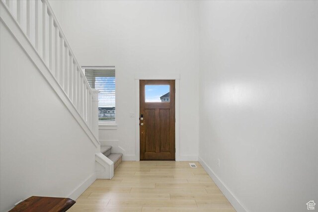 574 W 500 N, Smithfield, UT 84335 - foyer entrance with light wood finished floors, stairway, and baseboards