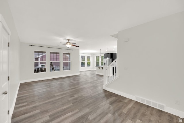 5103 W S Jordan Pkwy, South Jordan, UT 84009 - unfurnished living room with visible vents, ceiling fan, wood finished floors, and baseboards