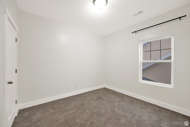 5103 W S Jordan Pkwy, South Jordan, UT 84009 - spare room with visible vents, dark carpet, and baseboards