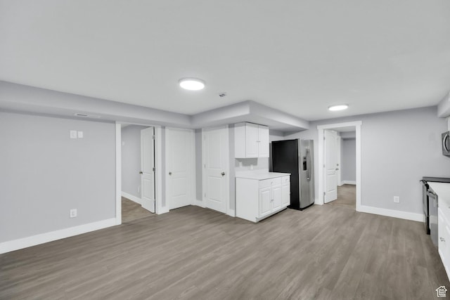 5103 W S Jordan Pkwy, South Jordan, UT 84009 - finished below grade area with baseboards, wood finished floors, and stainless steel fridge with ice dispenser
