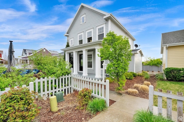 view of front facade featuring a porch and fence