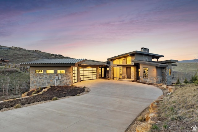 4014 Aspen Camp Loop, Park City, UT 84098 - prairie-style house with concrete driveway, an attached garage, and stone siding