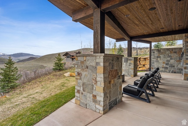 4014 Aspen Camp Loop, Park City, UT 84098 - view of patio / terrace with an outdoor stone fireplace and a mountain view