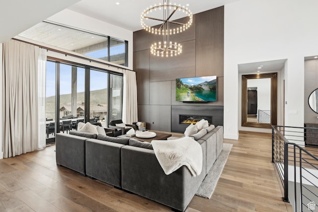 4014 Aspen Camp Loop, Park City, UT 84098 - living room featuring a towering ceiling, light wood finished floors, and an inviting chandelier