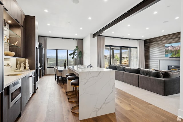 4014 Aspen Camp Loop, Park City, UT 84098 - kitchen with a breakfast bar area, a sink, a kitchen island, open floor plan, and modern cabinets