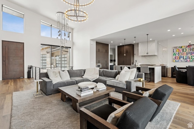 4014 Aspen Camp Loop, Park City, UT 84098 - living area with light wood-type flooring, recessed lighting, a notable chandelier, and a towering ceiling