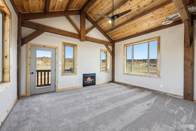 46997 W Thunder Ridge Rd, Fruitland, UT 84027 - carpeted spare room with wooden ceiling, a warm lit fireplace, lofted ceiling with beams, ceiling fan, and baseboards