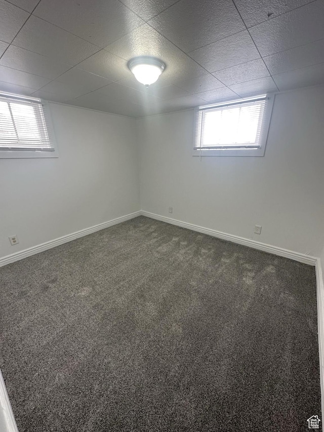 983 29th St, Ogden, UT 84403 - below grade area with healthy amount of natural light, dark colored carpet, and a paneled ceiling