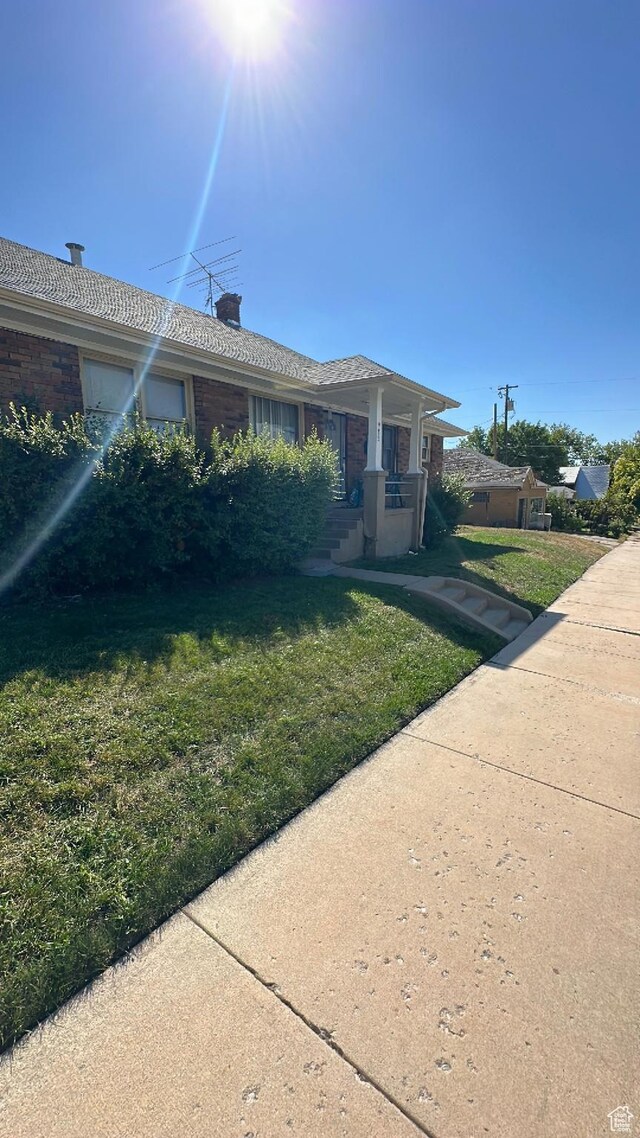 983 29th St, Ogden, UT 84403 - view of front of property with a front yard and a chimney