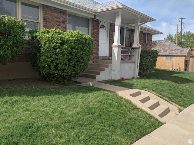 983 29th St, Ogden, UT 84403 - entrance to property with brick siding, a lawn, and a shingled roof