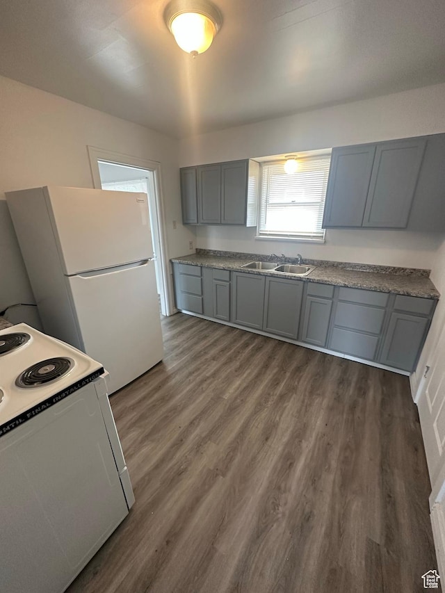 983 29th St, Ogden, UT 84403 - kitchen with white appliances, gray cabinetry, and dark wood-type flooring