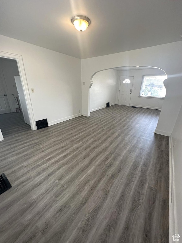 983 29th St, Ogden, UT 84403 - unfurnished living room with dark wood-type flooring and arched walkways