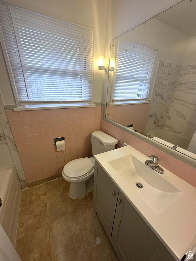 983 29th St, Ogden, UT 84403 - bathroom featuring vanity, tile walls, tile patterned floors, and  shower combination