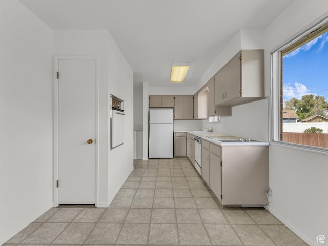 8323 S Adams St, Midvale, UT 84047 - kitchen with white appliances, light countertops, healthy amount of natural light, and baseboards