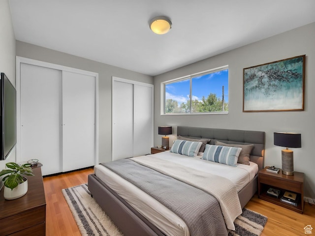 8323 S Adams St, Midvale, UT 84047 - bedroom featuring two closets and light wood-style floors