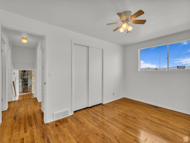 8323 S Adams St, Midvale, UT 84047 - unfurnished bedroom with hardwood / wood-style floors, baseboards, a closet, and ceiling fan
