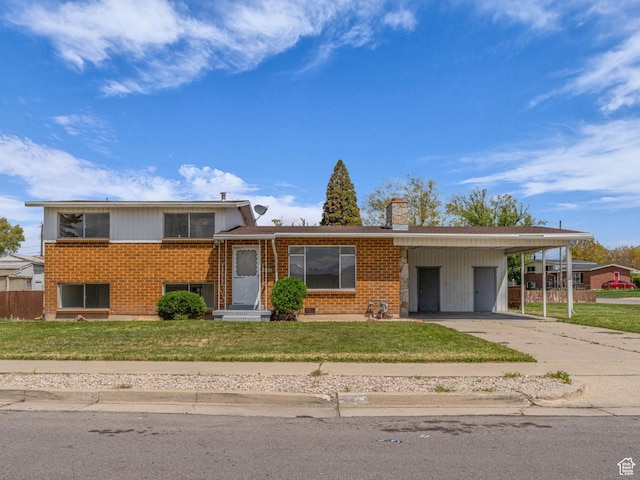 8323 S Adams St, Midvale, UT 84047 - split level home with concrete driveway, brick siding, a chimney, and a carport