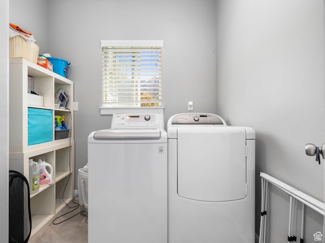 laundry area featuring light tile patterned flooring, independent washer and dryer, and laundry area
