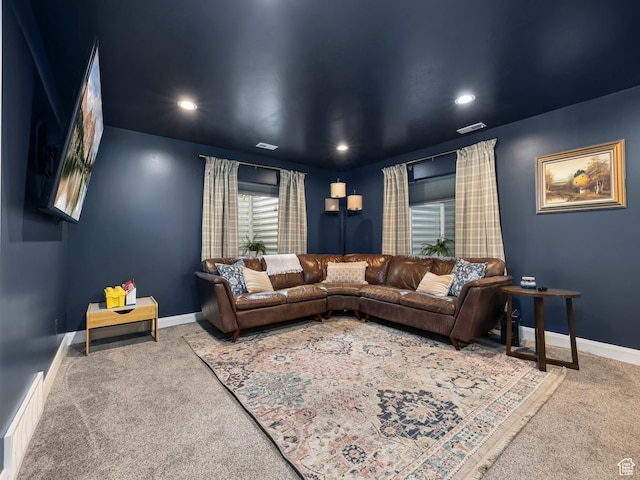 carpeted living area featuring visible vents, recessed lighting, and baseboards